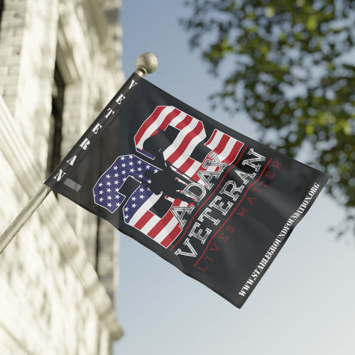 A patriotic flag featuring the text “22 A Day — Veteran Lives Matter” with an American flag design and soldier silhouette, raising awareness for veteran suicide prevention.