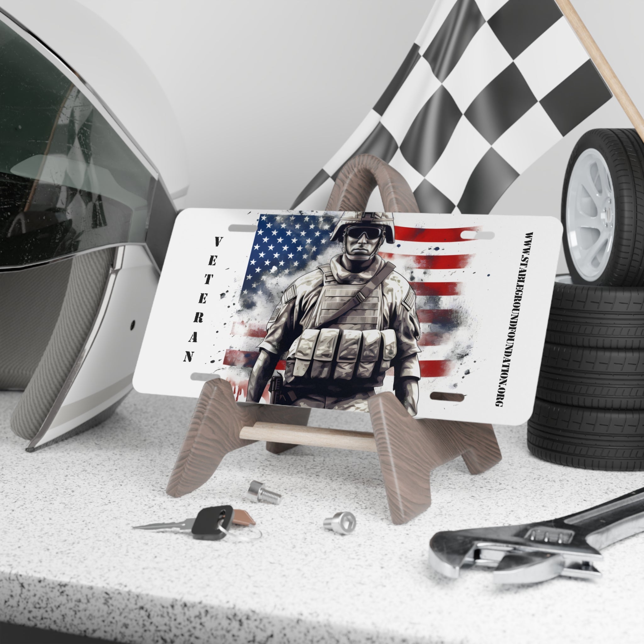 White vanity license plate featuring a soldier in tactical gear with the American flag in the background and “Veteran” text.