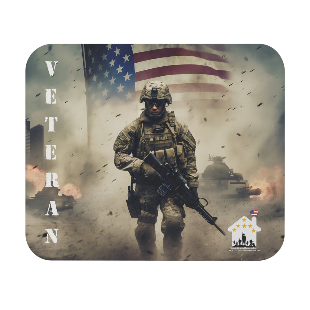 Mouse pad featuring U.S. soldier walking through battlefield with American flag and tanks in the background, honoring veterans.