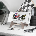 White license plate with the word “LOVE” spelled out using combat boots, an American flag heart, rifles, and camouflage lettering. Text below reads “Our Veterans.”