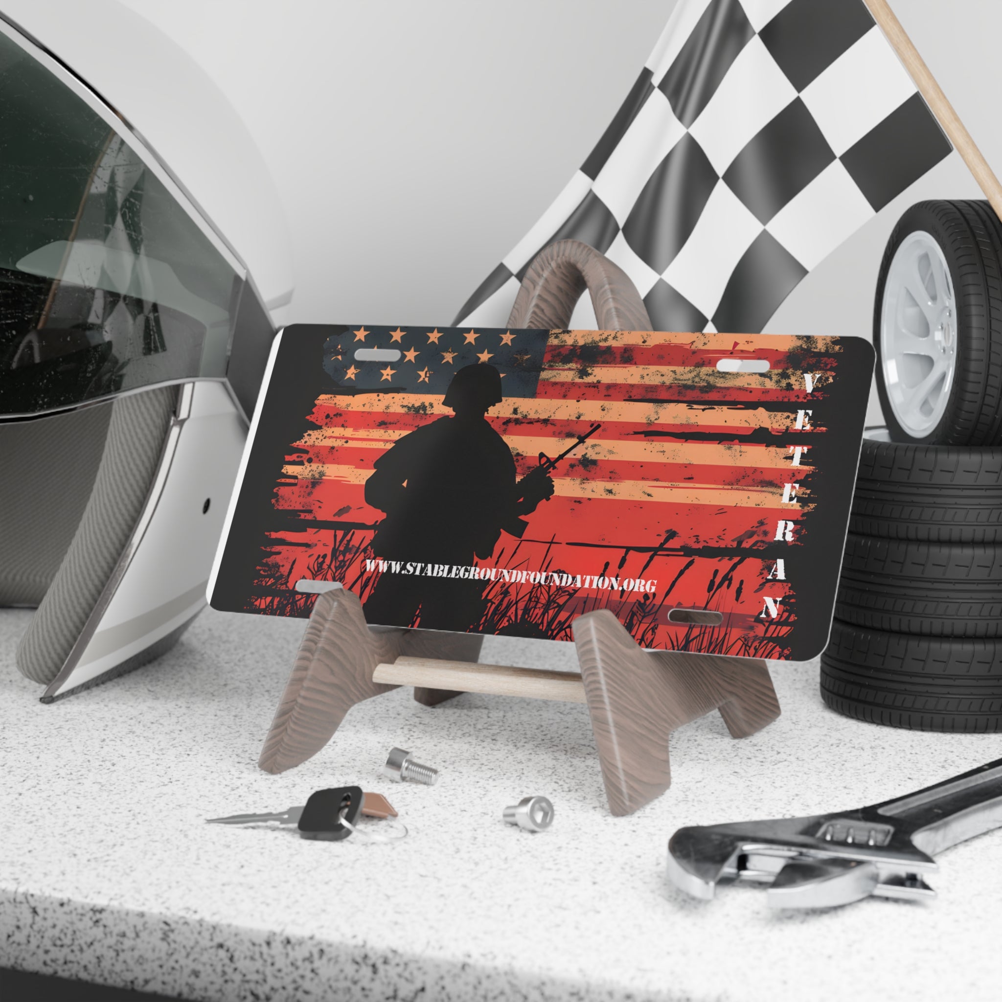 Patriotic license plate featuring soldier silhouette holding rifle over distressed American flag background with the word veteran.